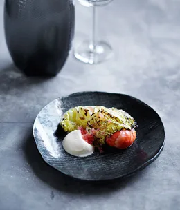 Fire-roasted marron with cabbage leaves, finger lime and fresh cream