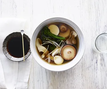 Silken tofu in a dashi broth with mushrooms and broccolini