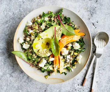 Avocado bowl with quinoa, kale and tahini lemon dressing