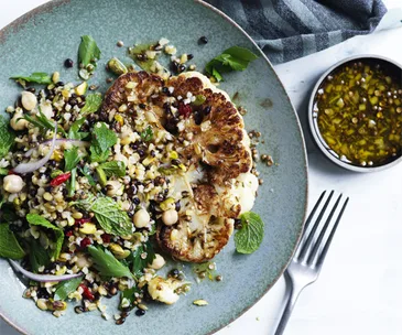 Cauliflower steaks with grain salad and spiced dressing