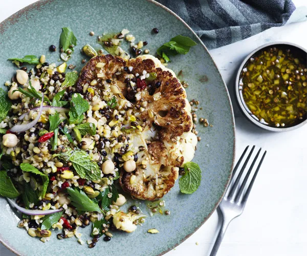 Cauliflower steaks with grain salad and spiced dressing