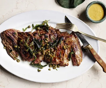 Flank steak with mustard sauce, herbs and capers