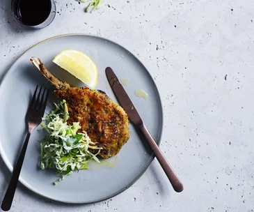 Veal cotoletta with cabbage, mint, apple and dill