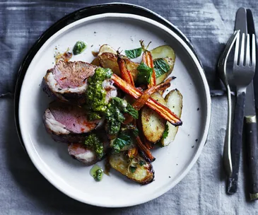 Mini lamb roast with baby carrots, kipflers and carrot-top pesto