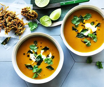 Spiced pumpkin soup with onion bhajis and curry leaves