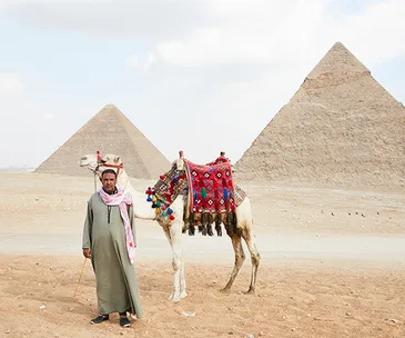 Camel man Hisham Gabri with his charge, Captain Cook, in Giza.
