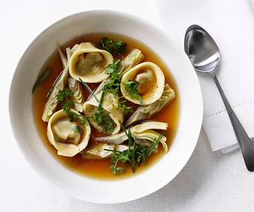 Chicken brodo with artichoke tortellini and spring herbs