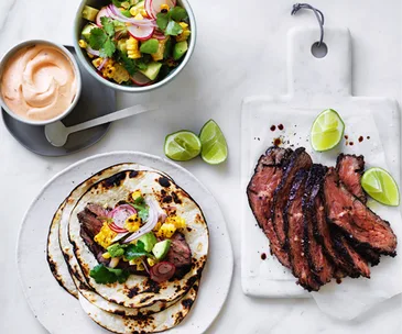 Flank steak tacos with corn, avocado and coriander