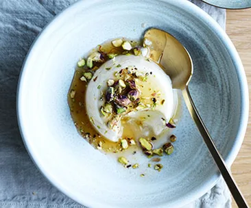 Vanilla-yoghurt bavarois with saffron-cardamom syrup and pistachios