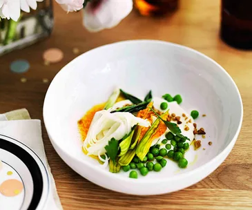 Pea salad, curd, pine nuts, blossoms, white asparagus and carrot juice dressing