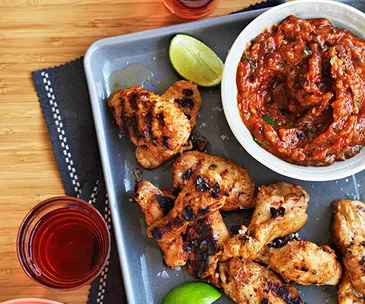 Spiced chicken wings with roast garlic and chipotle salsa