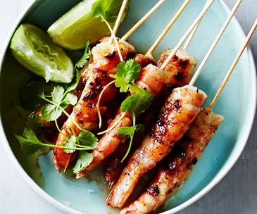 Charred prawns on skewers with lime