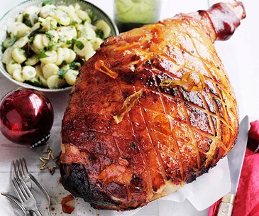 Orange-glazed ham with potato and parsley salad