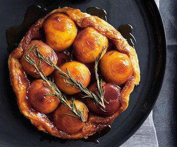 Peach and rosemary tarte Tatin with runny cream