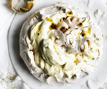 Coconut pavlova with passionfruit jam and lychees