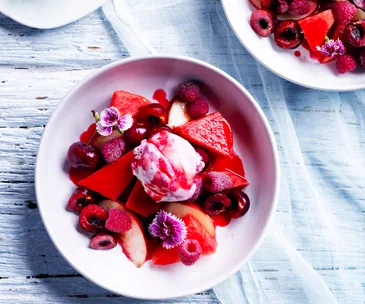 Watermelon fruit salad with ice-cream and raspberry-pepper syrup