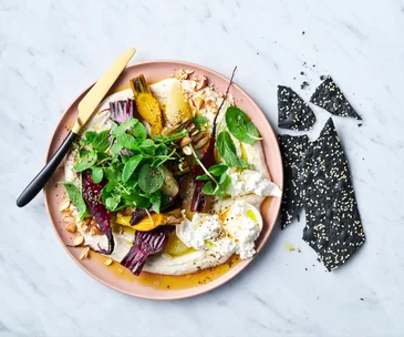 pink plate loaded with white dip, burrata and beetroots