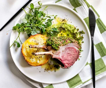 Lamb rib roast with pommes Anna and pea purée