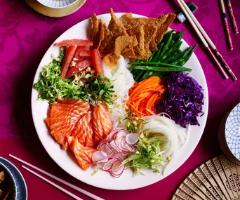 Bird's eye view of a Prosperity salad on a pink table