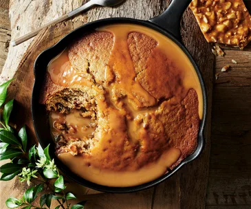 Cast iron pan with cinnamon myrtle-spiced sticky date pudding, macadamia brittle and butterscotch sauce