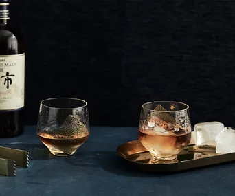 Japanese whisky in two glasses and a bottle of Japanese whisky in the background