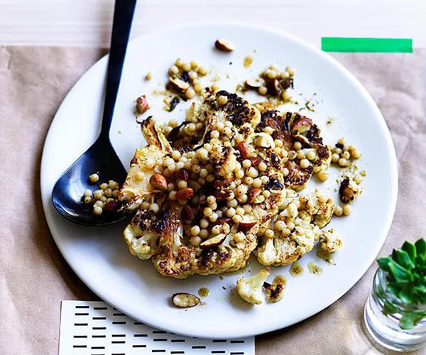 Roast cauliflower with almonds, Israeli couscous and za&rsquo;atar