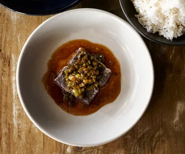 Morks restaurant Canberra, ACT. Photo of beef short ribs in a bowl with sauce poured over the top.