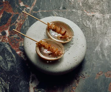 Etta restaurant in Melbourne abalone skewers served in their shells.