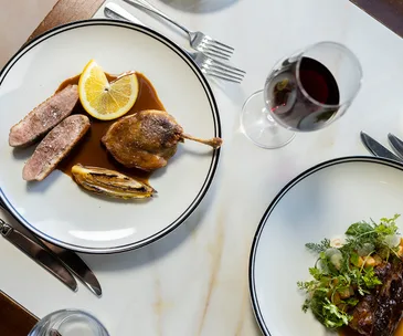 Market Bistro in Maroochydore, Sunshine Coast Queensland. Photo of red wine served with duck and a salad.