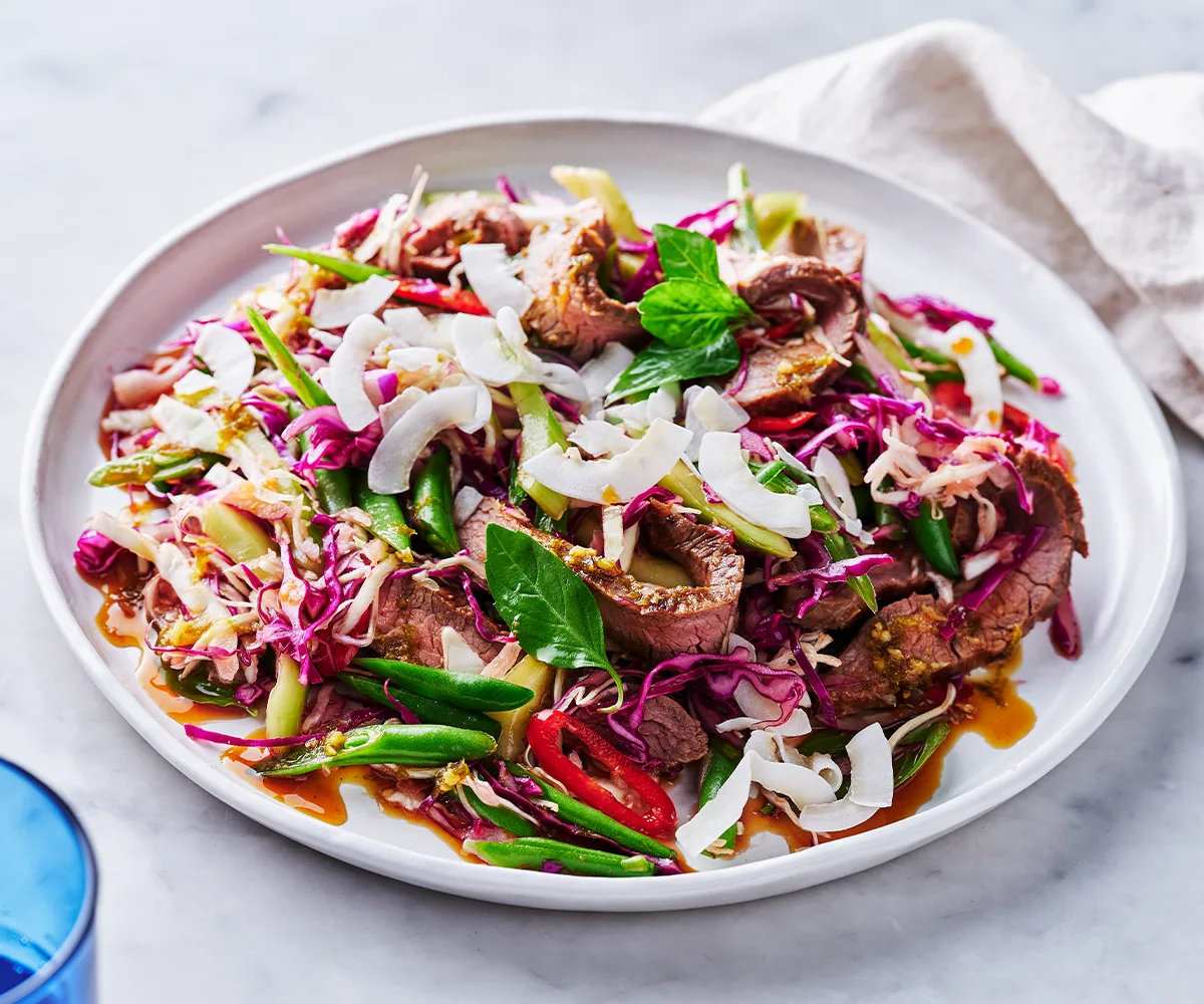 A plate of seared beef tossed through a palm sugar and coconut slaw.