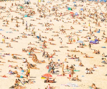 Summer in the city - photo of sand at Bondi Beach crowded with people in summer