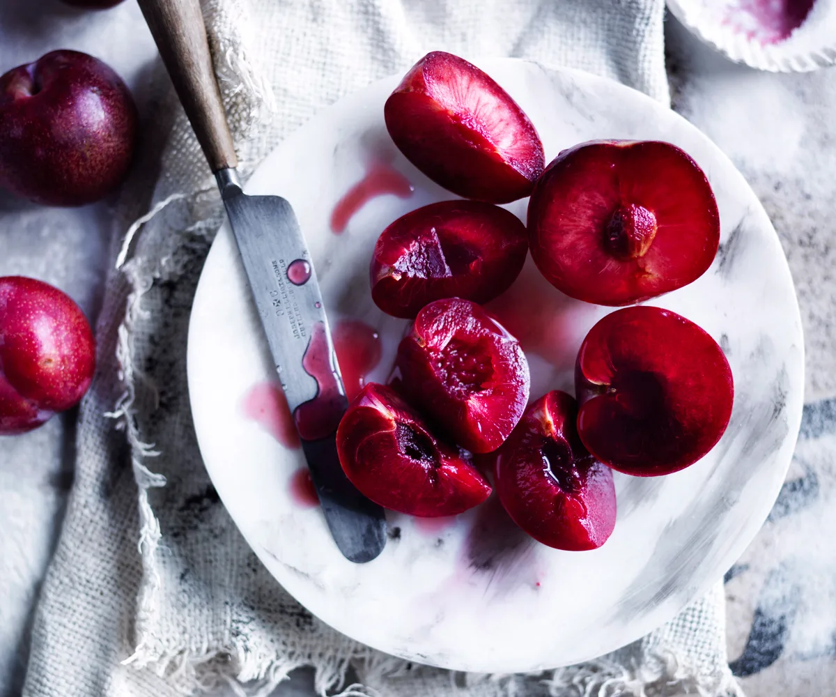Plum recipes - Gourmet Traveller's best plum recipes. Photo of halved and quartered plums on a plate