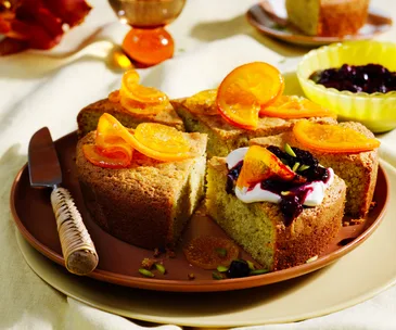 Olive oil pistachio cake topped with candied oranges and a generous dollop of crème fraîche and berry compote. 