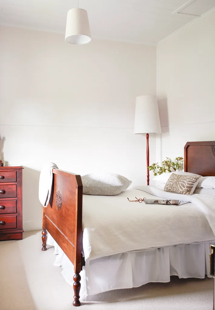 Classic cottage bedroom with antique furniture.