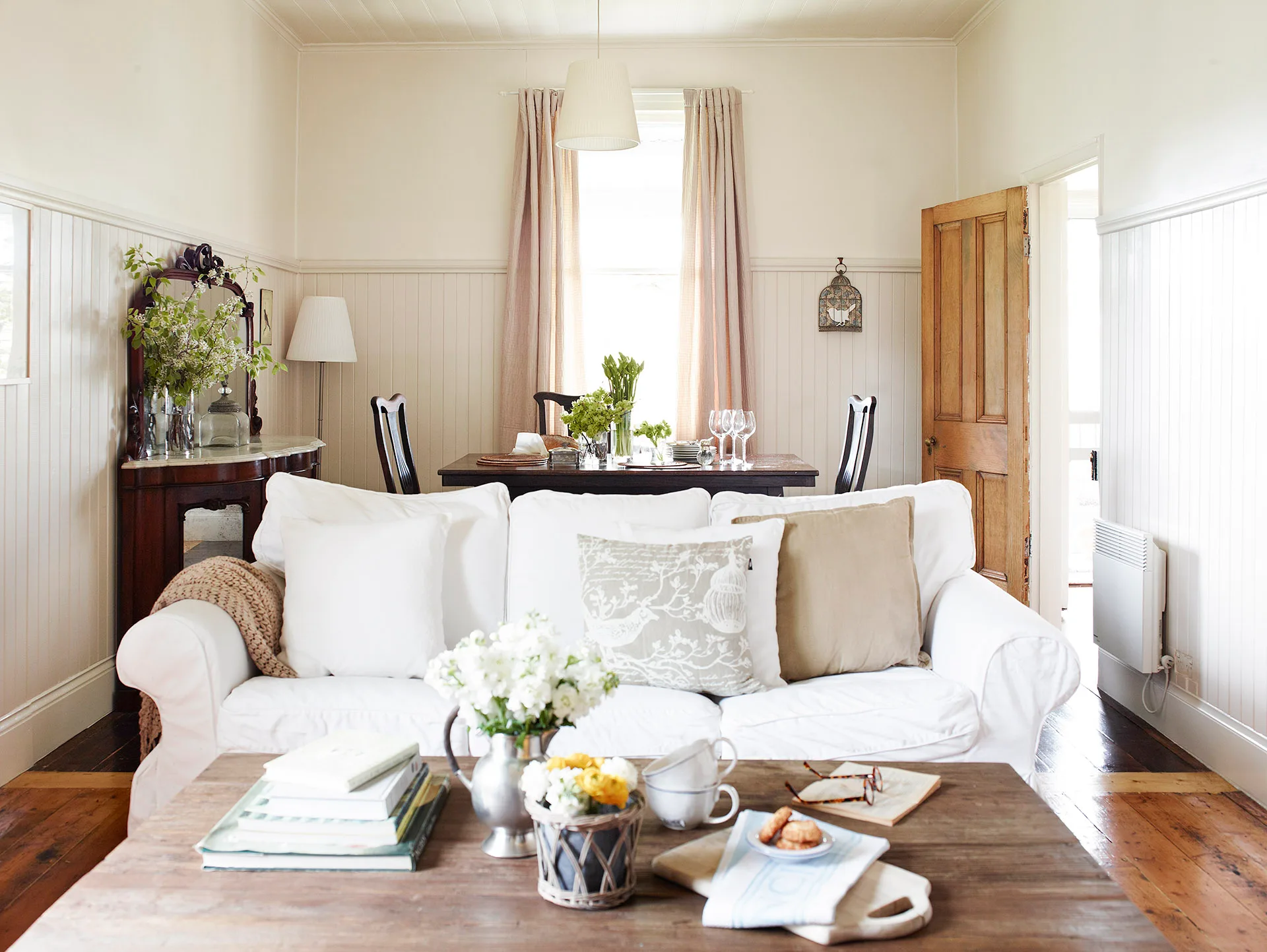 Classic cottage living and dining room featuring a mix of vintage and antique furniture and Ikea gems.