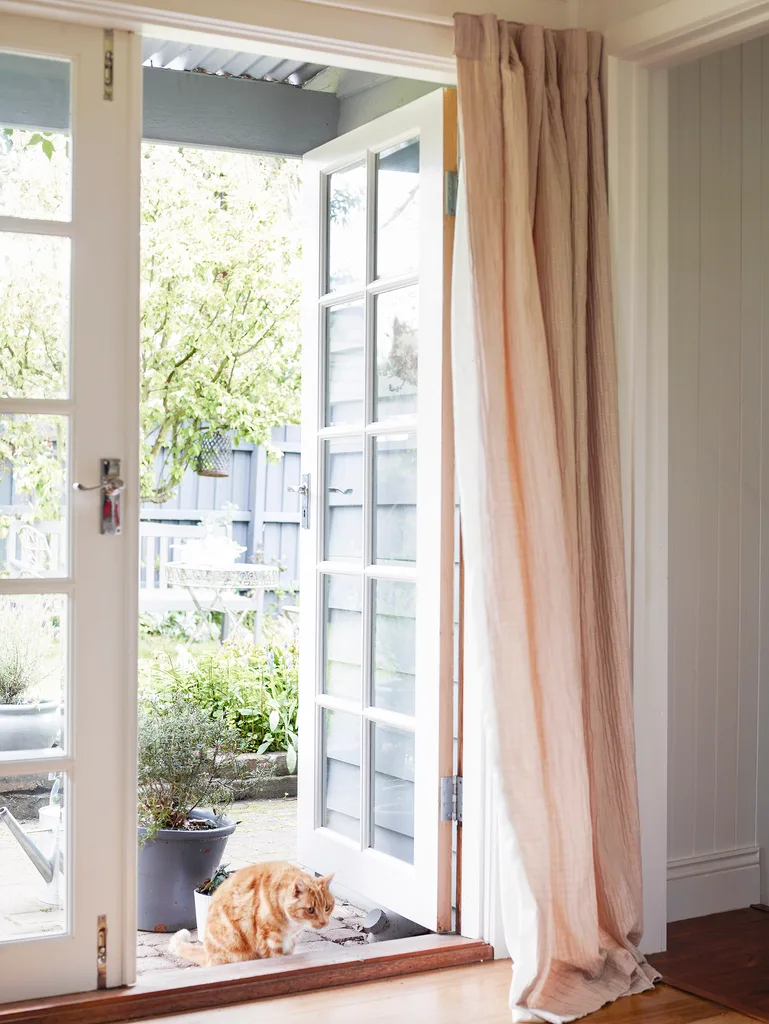 Cottage French doors leading out to garden.