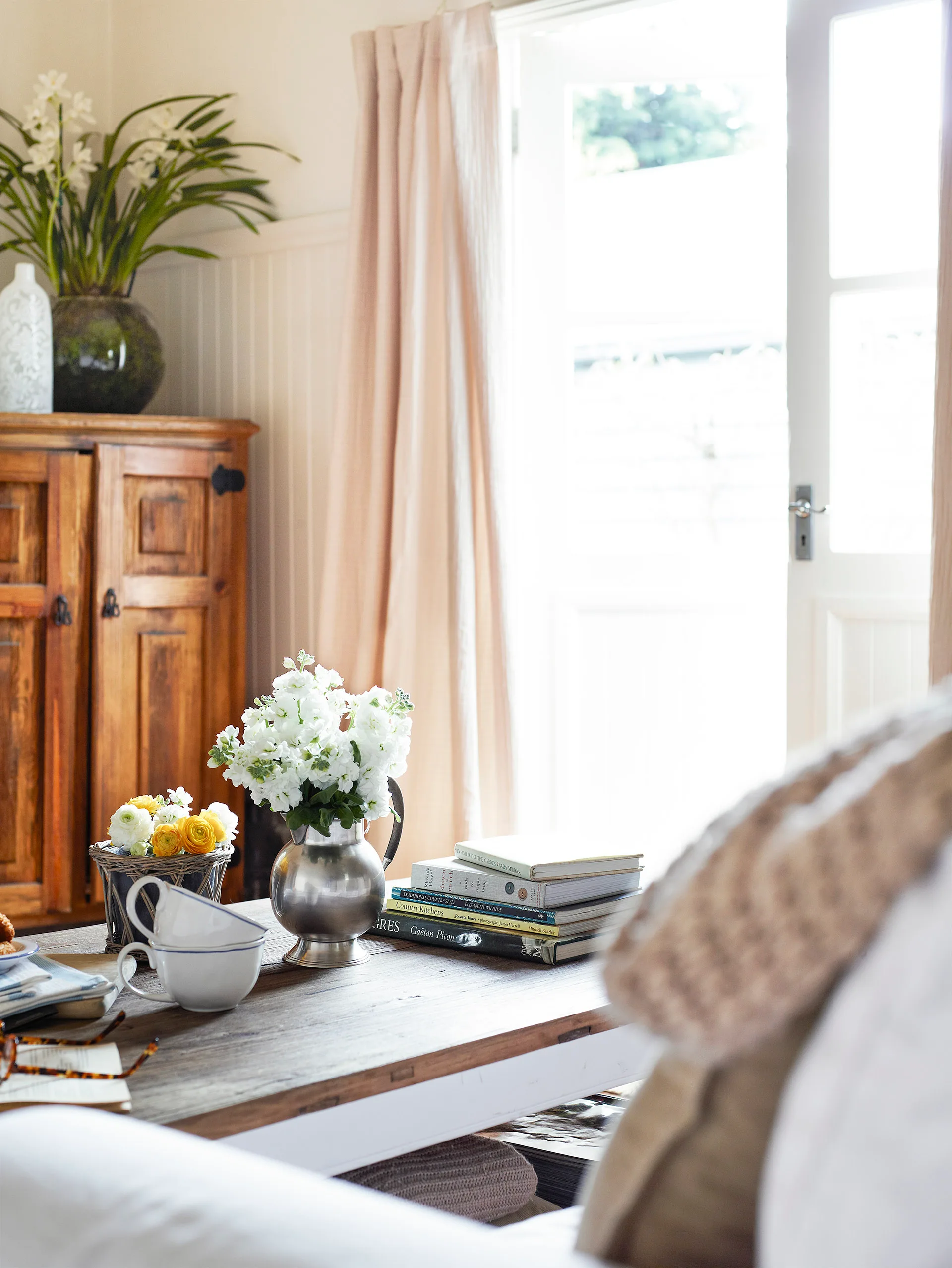 Cottage living room with fresh flowers on the coffee table.