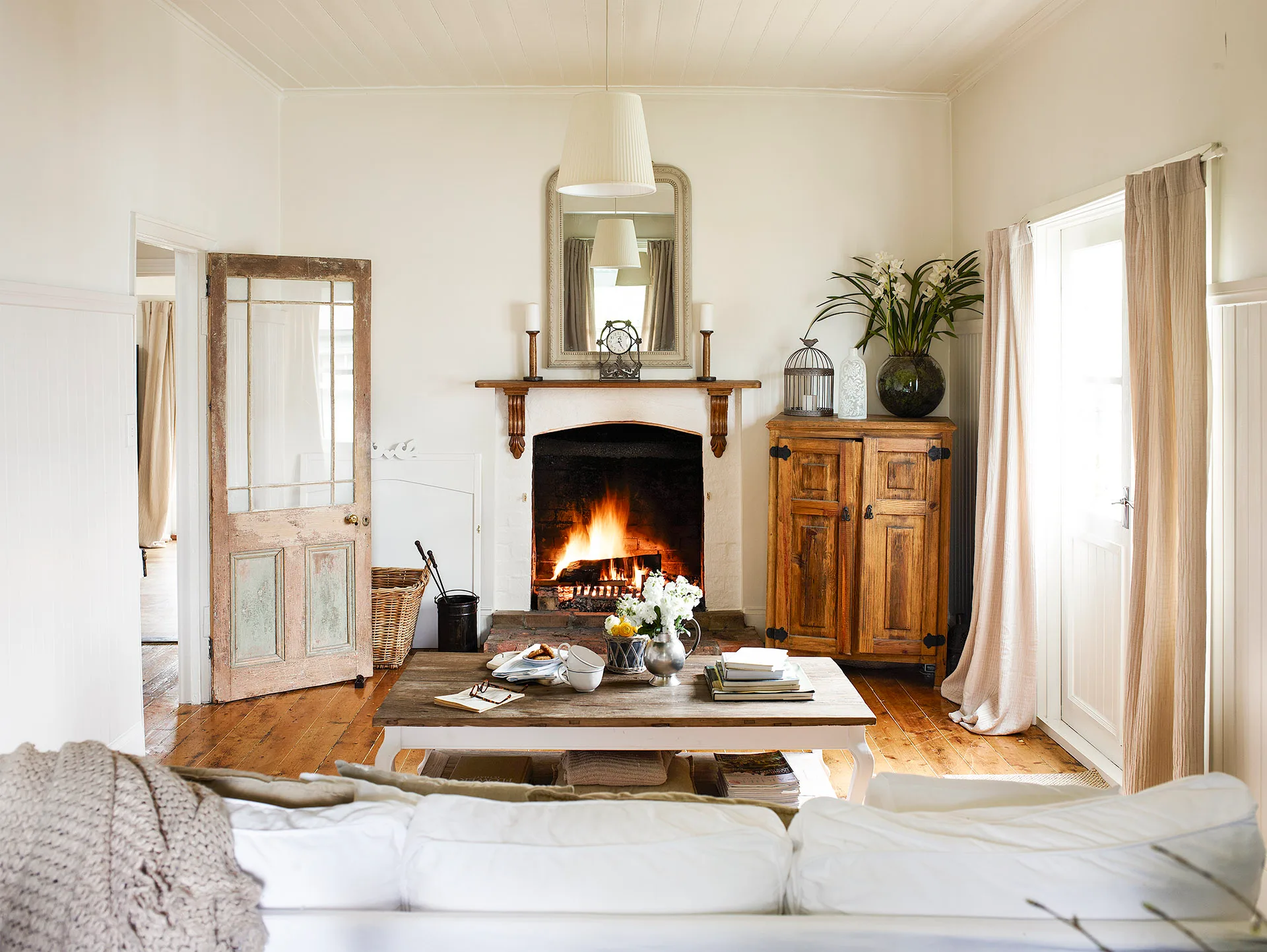 Cottage style living room with open fireplace.
