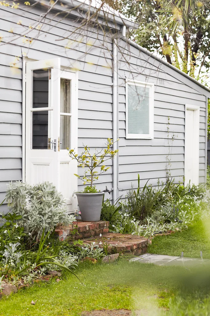 Grey and white exterior of a renovated cottage in regional Victoria.