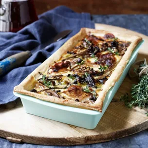 Wild mushroom and Gruyere cheese flan in a tray.