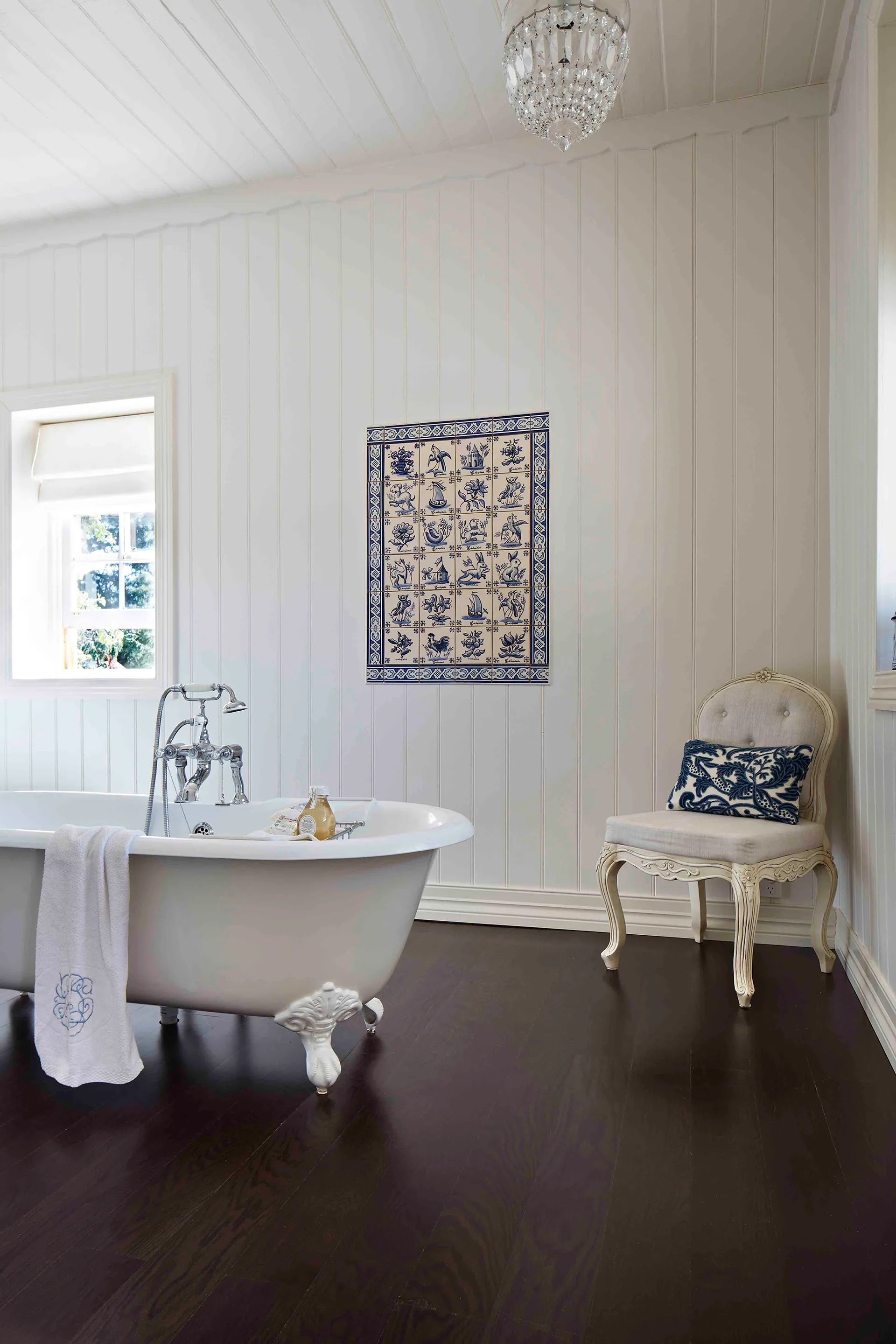 French provincial style guest bathroom with claw-footed bath tub.