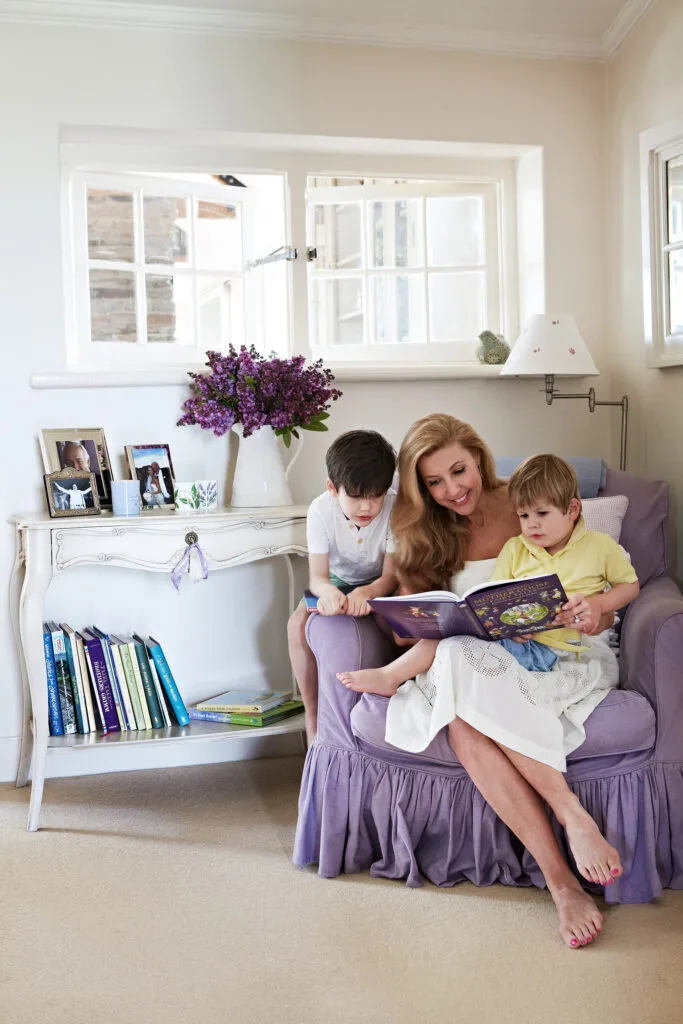 Catriona Rowntree and her sons reading a book on a purple chair at her country home in Victoria.