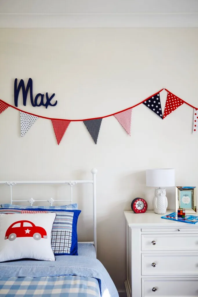 Kids room with blue and red colour scheme and bunting.