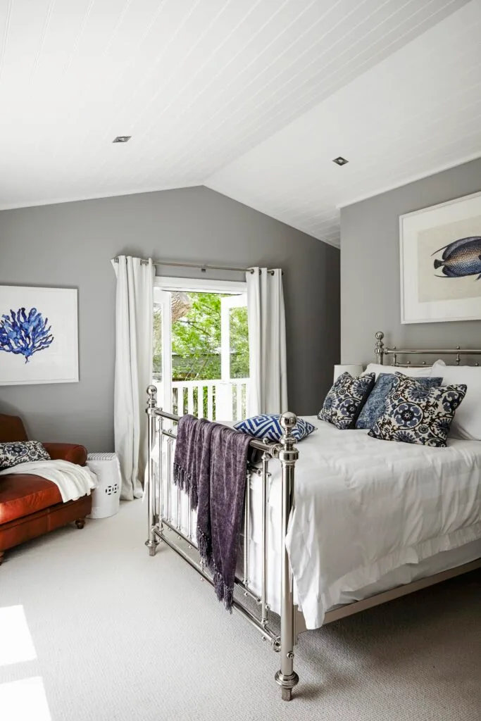 Grey Hamptons style bedroom with coral print on wall.