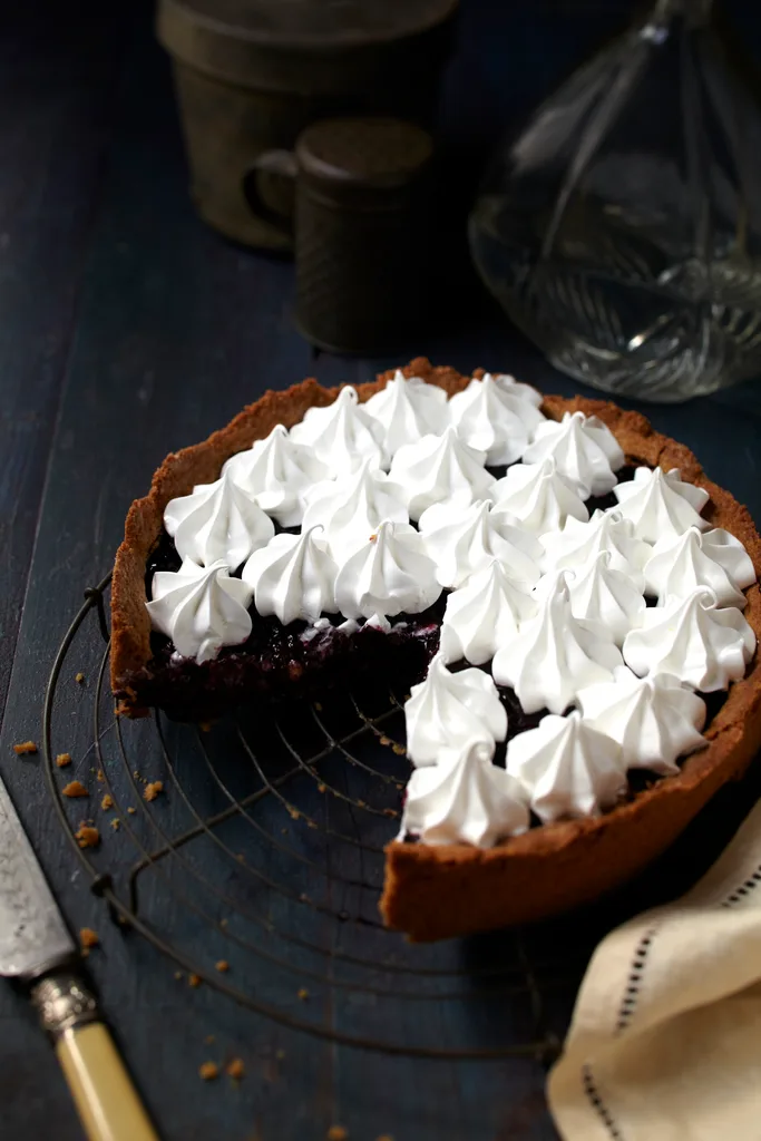 A gluten free cherry pie with piped meringue over the top