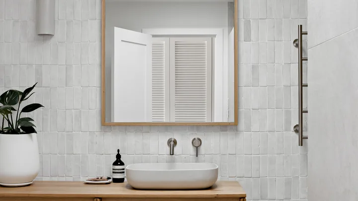 Modern bathroom with timber vanity and stone composite sink.