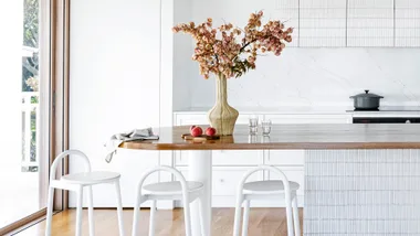 White and timber coastal kitchen with whie bar stools