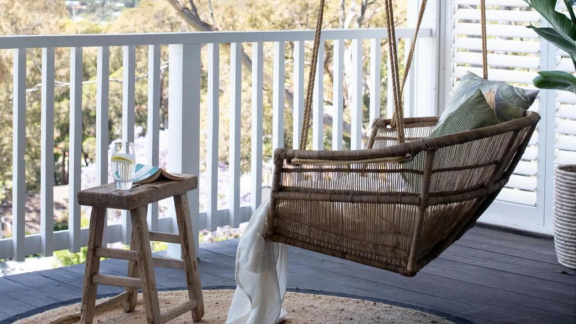A rattan swing chair on the balcony.