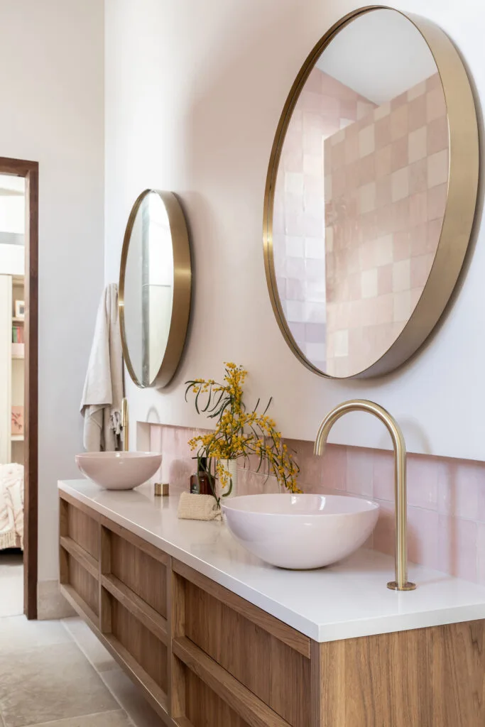 Pink and timber bathroom with brushed brass tapware and pink tiled backsplash created by Shelley Craft for her Pacifico House project.