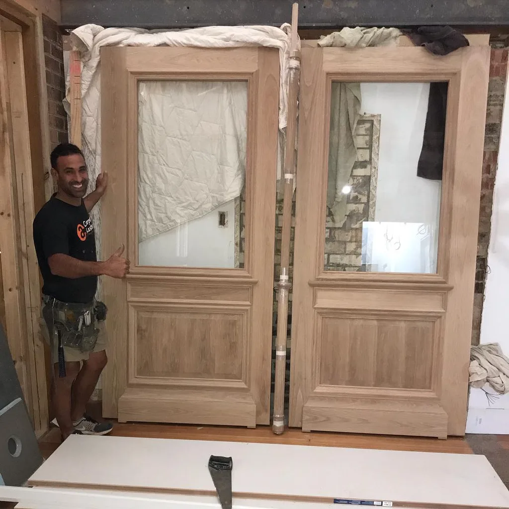 Adam Docile working on their front doors